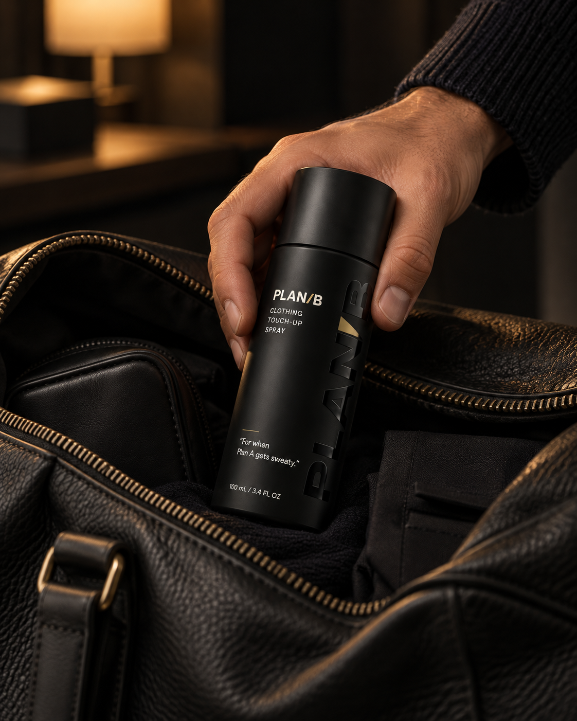 Hand reaching for Plan B in a leather bag by lamplight
